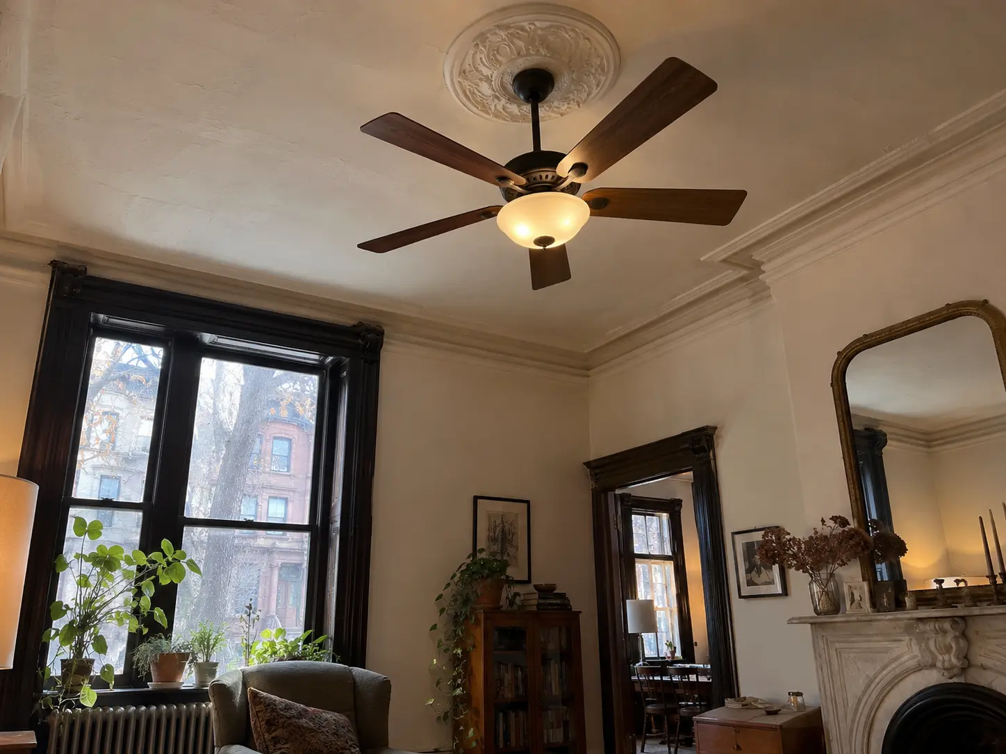 Ceiling fan beneath an ornate ceiling medallion in a Brooklyn parlor